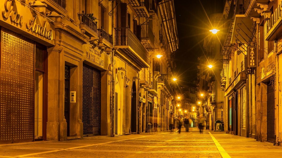 illuminated-street-amidst-buildings-night_1200px_wide